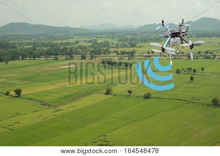 internet of things(industrial agriculture and smart farming concept)farmer use drone for keeping the data in the field by using the signal and the detector
