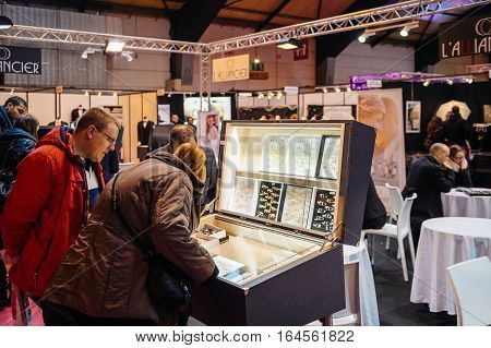 Strasbourg France - Jan 8 2017: Couple Choosing Wedding Rigns With Booths And People At Salon Du Mar