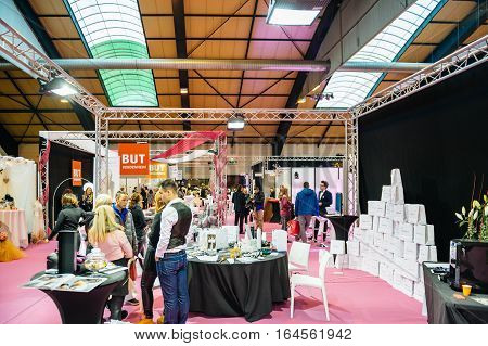 STRASBOURG FRANCE - JAN 8 2017: Couple visiting multiple booths and people at Salon du Marriage the guide exhibition for bridal and formal wear industry