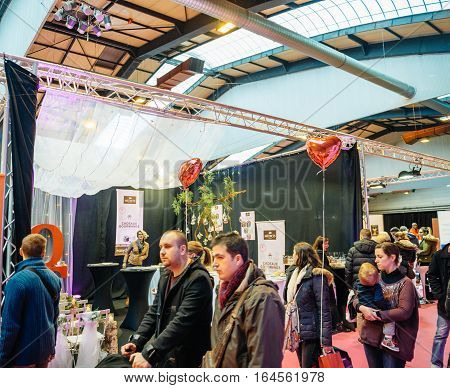 STRASBOURG FRANCE - JAN 8 2017: Gourmand gifts booth with customers at Salon du Marriage the guide exhibition for bridal and formal wear industry