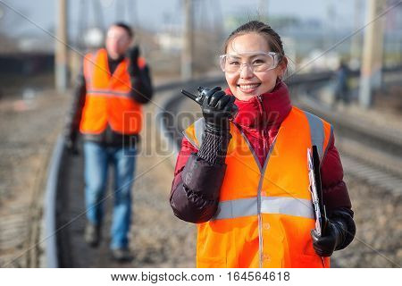 Man and a woman railroad workers maintaing railway