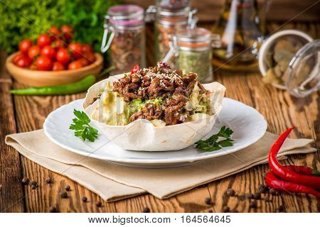 Doner kebab - fried chicken meat with vegetables in pita bread