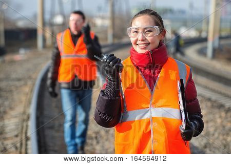Man and a woman railroad workers maintaing railway