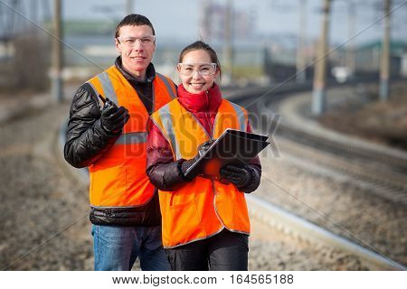 Man and a woman railroad workers maintaing railway