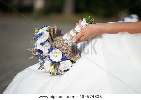 Beautiful bride with bouquet before wedding ceremony