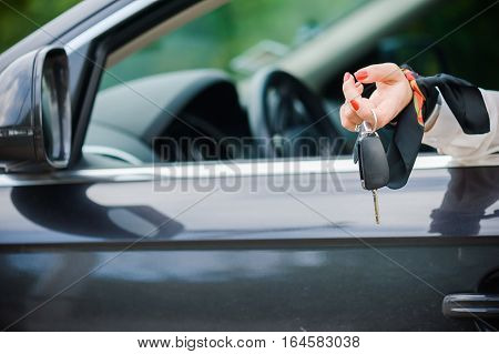 Car Keys. Seller woman hand giving keys