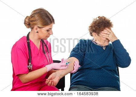 Picture of an elderly woman receiving an injection - isolated background