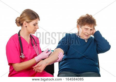 Picture of an elderly woman receiving an injection - isolated background