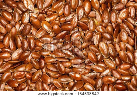 Flax, Flaxseeds full background. One hundred grams of ground flaxseed supplies about 534 calories, 41 grams of fat, 28 grams of fiber, and 20 grams of protein. Image taken with macro lens.