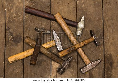 six hammers on wooden surface, hand tools concept