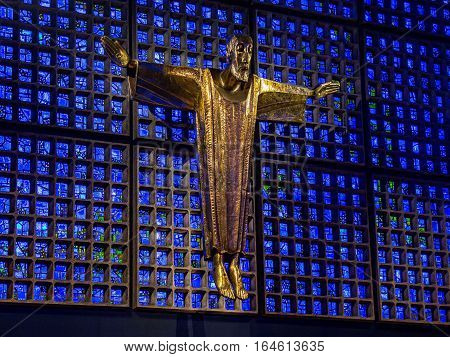 Berlin, Germany - January 16, 2014: Interior of Kaiser Wilhelm Memorial Church (modern building). Crucified Jesus Christ, by architect Karl Hemmeter