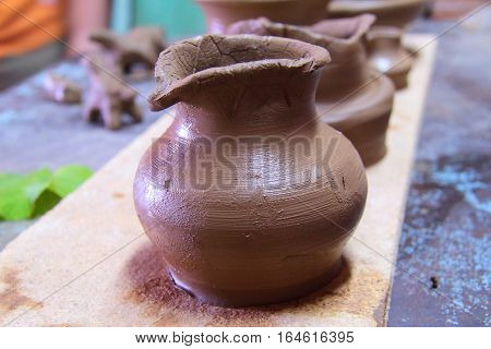 A clay pot, pottery craft, moulding the pot with your hands, sculpting hands