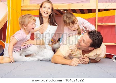 a family are lying on the nursery's floor.