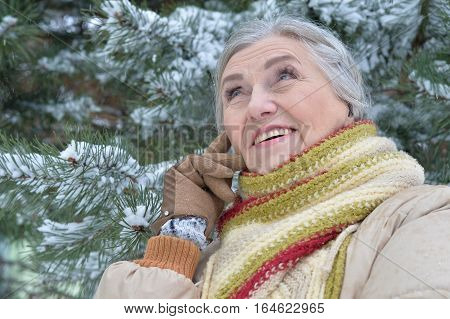 happy mature woman posing outdoors in winter