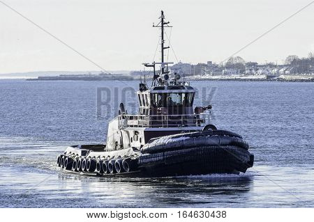 New Bedford Massachusetts USA - January 9 2017: Tug on Acushnet River in New Bedford Massachusetts on cold winter morning