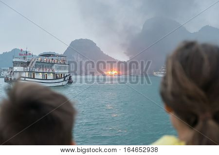 HALONGBAY VIETNAM - JAN 10 2017 : Two kid looking a fire boat.