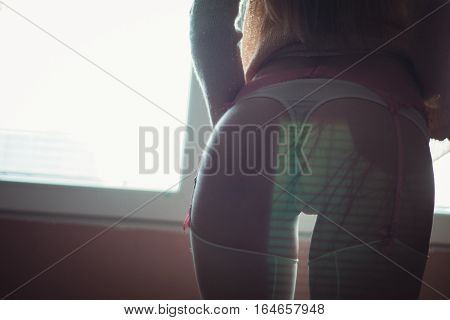 silhouette of a woman's body by the window