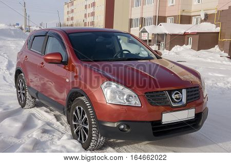 Nissan Qashqai in red color. This is crossover that combines modark design and compact hatchback refinement with functionality