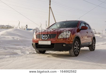 Nissan Qashqai in red color. This is crossover that combines modark design and compact hatchback refinement with functionality