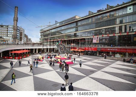 STOCKHOLM SWEDEN - AUGUST 19 2016: Pedestrian walk on Sergels Torg with the glass obelisk Kristallvertikalaccent It is central public square in the city in Stockholm Sweden on August 19 2016.