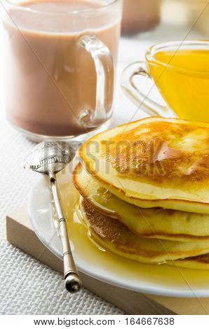 Glass Mug With Cocoa, Silver Spoon, Honey And Pancakes