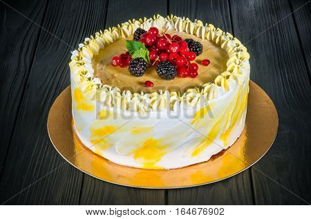 Delicious cake on a wooden black background