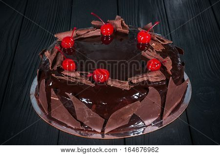 Delicious cake on a wooden black background