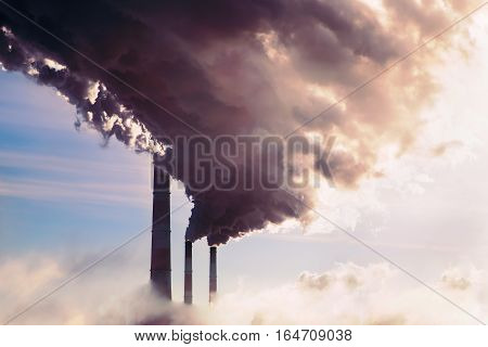 Smoking chimney of industrial buildings complex. high pollution from coal power plant