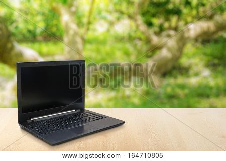 Computer Laptop on the table blur background with bokeh business technology concept