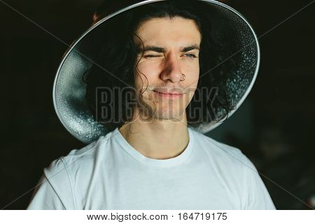 Portrait of a young man in a strange unusual hat