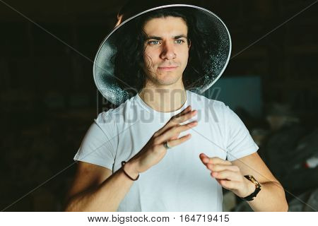 Portrait of a young man in a strange unusual hat