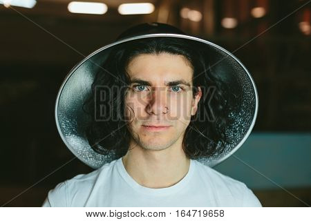 Portrait of a young man in a strange unusual hat