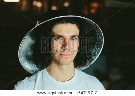 Portrait of a young man in a strange unusual hat