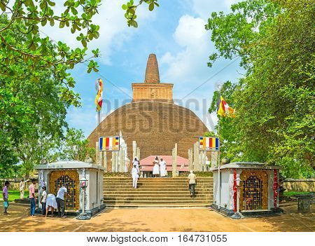 ANURADHAPURA SRI LANKA - NOVEMBER 26 2016: The view on Abhayagiri Stupa through the grenery of Mahamevnawa Park on November 26 in Anuradhapura.