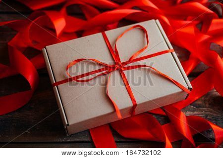 Valentine's Day Concept. Gift With Red Bow  On The Wooden Backgr