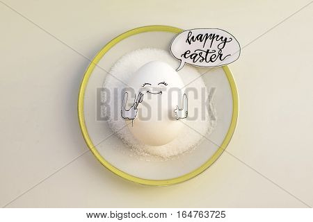 Nice egg on a saucer with hands smiling. Happy easter