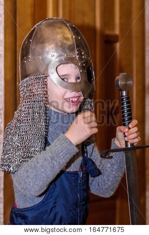 Kolomna Russia - January 03 2017: little boy was allowed to try Blacksmith Settlement museum exhibits by Andrey Kopylov aka linkpusher