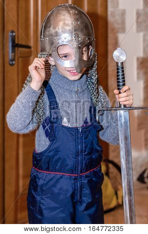 Kolomna Russia - January 03 2017: boy trying armor from the Blacksmith Settlement museum collection by Andrey Kopylov aka linkpusher