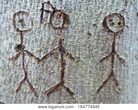 Symbol of a group of people carved in tree bark
