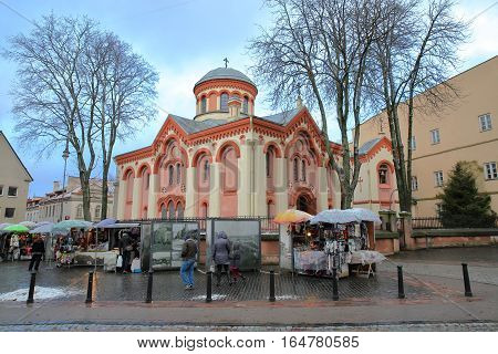 VILNIUS, LITHUANIA - DECEMBER 28, 2016: St Paraskeve Orthodox Church with markets stalls in the foreground