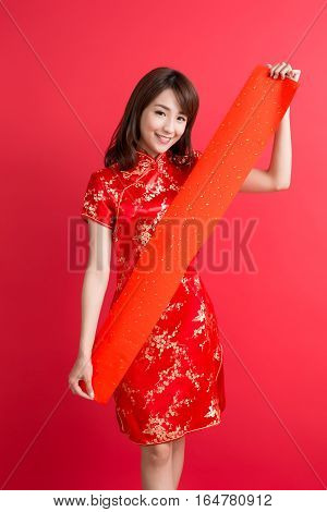 beauty woman wear cheongsam and show couplets with chinese new year