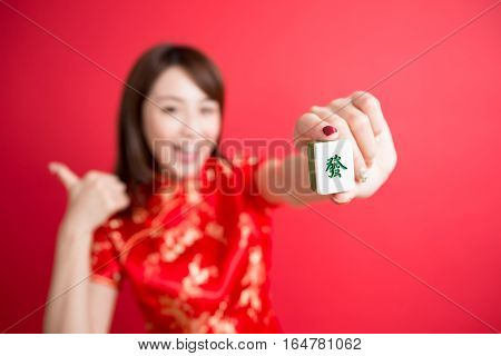 beauty woman thumb up and show mahjong to you in chinese new year - Rich and wealthy text on girl hand in Chinese words