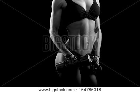 Step by step. Cropped black and white shot of a stunning female athlete with strong sexy muscular body posing at studio copyspace on the side