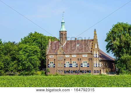Castle-like building in a rural setting in the Netherlands. The current building was built around 1936 on the site where originally was a real castle from the 14th century. This castle was destroyed by fire and the current building contains some elements