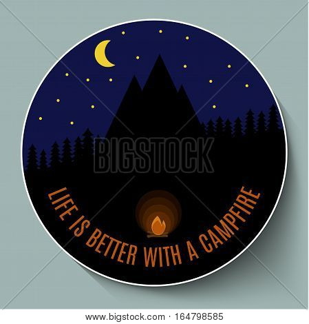 campfire at night on a background of mountains