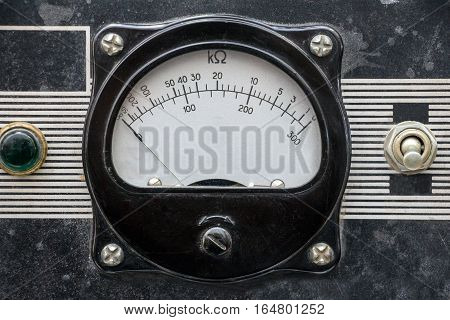 Old measuring instrument with an arrow. Retro dusty analog device