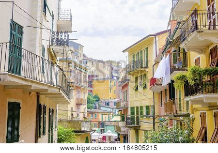 Manarola town Riomaggiore La Spezia province Liguria northern Italy. View of the colourful houses on surrounding hills balconies and windows. Part of the Cinque Terre National Park and a UNESCO World Heritage Site.