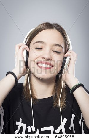 Happy girl listening to music with headphones