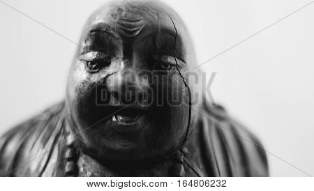 wooden statue laughing Buddha. The character of Chinese Buddhism