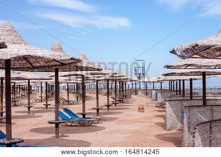 group of straw beach umrellas on the Red sea